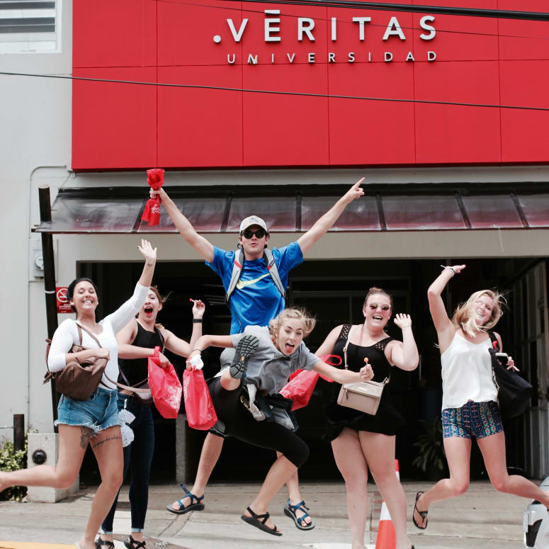 A group of students in front of an Universidad Veritas building in Costa Rica.
